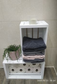 a shelf with toilet paper and towels on it