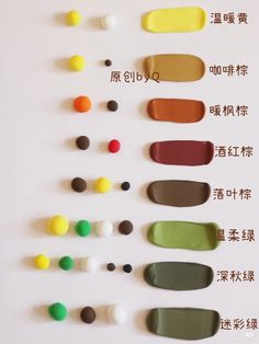 an assortment of different colored paints arranged on a white surface with chinese writing in the middle