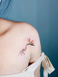 a woman with a tattoo on her shoulder and the word love written in cursive writing