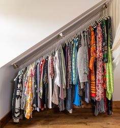 a bunch of shirts hanging on a rail