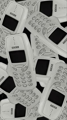 several cell phones are stacked on top of each other in the shape of an intricate pattern