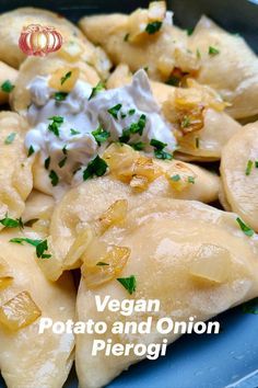 a blue plate topped with dumplings covered in cream