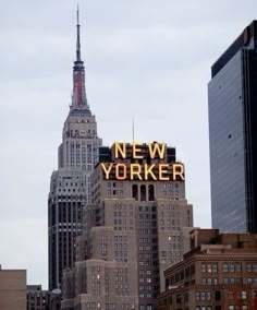 the new york sign is lit up on top of buildings