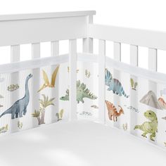 a crib bed with dinosaurs on it