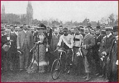 black and white photograph of people with bicycles