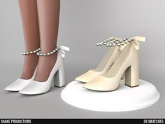 a pair of white high heeled shoes with pearls on the ankle and heels are shown