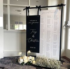 a table with flowers and a sign that says, welcome to my parents tag & caption