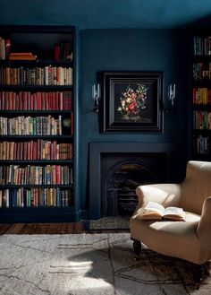 a chair in front of a book shelf filled with books