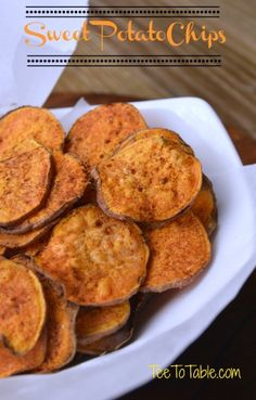 a white plate topped with fried potatoes on top of a wooden table