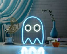 a neon ghost lamp sitting on top of a table