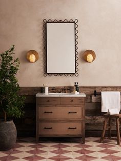 a bathroom with a sink, mirror and stool