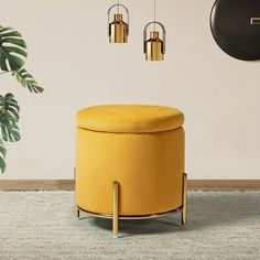 a living room with a yellow ottoman and black clock hanging on the wall above it