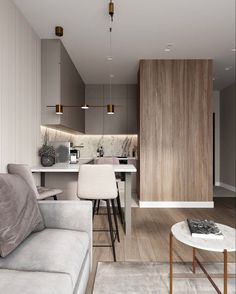 a living room filled with furniture next to a kitchen