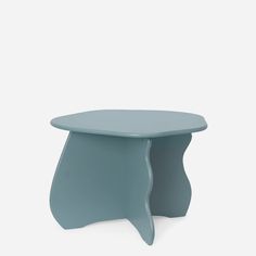 a small blue table sitting on top of a white floor