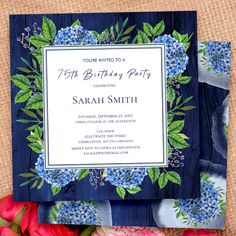 a birthday party with blue flowers and greenery