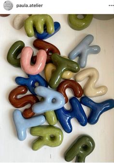 there are many different shapes and sizes of doughnuts on the table, including letters