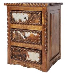 a wooden cabinet with three drawers and cow hides on the front, along with rope handles