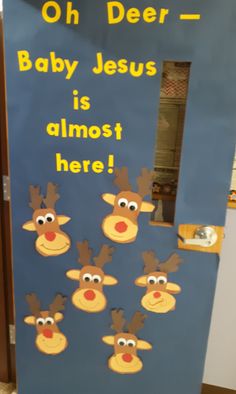 a door decorated with reindeer faces and the words oh deer baby jesus is almost here