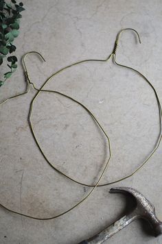 a pair of scissors are laying on the floor next to some wire and metal hooks