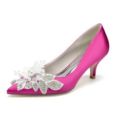 pink high heel shoes with white flowers on the toe and silver heels, all in satin fabric