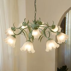 a chandelier with white flowers hanging from it