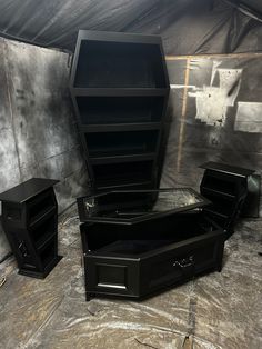 three black boxes sitting on top of a table next to each other in a room