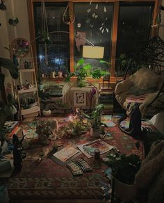 a living room filled with lots of plants and books on top of a carpeted floor