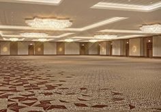 an empty ballroom with chandeliers and lights