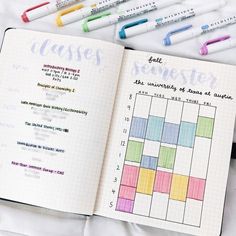 an open planner book with markers and pens