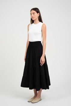 This tiered black maxi features a poplin fabric and an elastic smocked waist for the perfect fit. Maxi length Smocked elastic waist Tiered skirt Fully lined Fabric: poly SIZE GUIDE Measurements are approximate and taken while laying flat across the front. Not doubled. Small - Waist: 11” (elastic relaxed)Length: 35” Medium - Waist: 12” (elastic relaxed)Length: 35.5” Large - Waist: 13” (elastic relaxed)Length: 36” TRY-ON Jumpsuit Skirt, Baby Sale, Hair Fragrance, Black Maxi, Tier Skirt, Tiered Skirt, Small Waist, Sweater And Shorts, Poplin Fabric