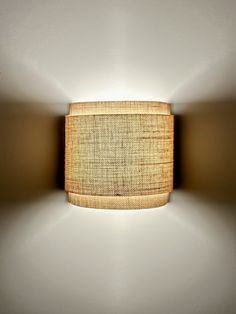 a light that is on the side of a wall with a cloth covering over it