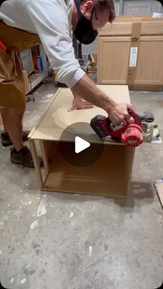 a man using a power tool to cut plywood