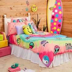 a bed room with a surfboard on the wall and other items in front of it