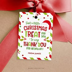 a christmas treat tag hanging from a red ribbon