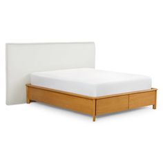 a bed with a wooden frame and white sheets