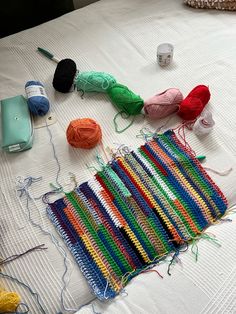 yarn and crochet supplies laid out on a bed