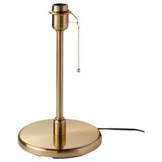 a brass colored table lamp with a chain hanging from it's end and a white background