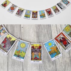 the taroti card garland is hanging on a wooden table with other taroti cards