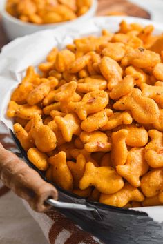 a bowl filled with macaroni and cheese on top of a table