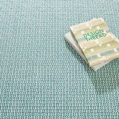 a book sitting on top of a blue and white rug