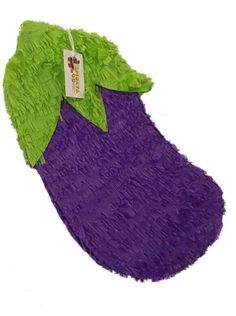 a purple and green object with a tag on it's collar, sitting in front of a white background