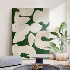 a living room with white walls and green art