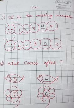 an open notebook with numbers and fish drawn on the page, which has been written in red