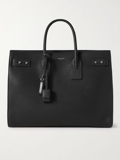 Introduced in 2013, SAINT LAURENT's 'Sac de Jour' is a core style for the French house. This large version has been crafted in Italy from black full-grain leather that will become less rigid over time and take on a more relaxed silhouette. The nubuck-lined interior is fitted with a handy removable zipped pouch, perfect for keeping smaller items safe and separated. Saint Laurent Men Bag, Large Designer Bag, Tote Bag For Men, Saint Laurent Collection, Saint Laurent Tote, Black Leather Briefcase, Luxury Tote Bags, Fancy Bags, Black Leather Handbags