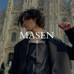 a man standing in front of a tall building with the words masen on it