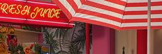 a store front with an american flag and red neon sign on it's side