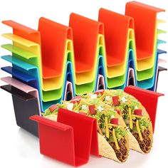 several different colored trays with tacos and mexican food in front of each other