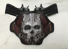 a leather holster with a skull painted on it