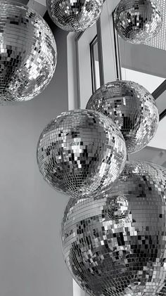 several shiny disco balls hanging from the ceiling