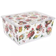 a clear plastic box with flowers on the lid and bottom, sitting on a white surface